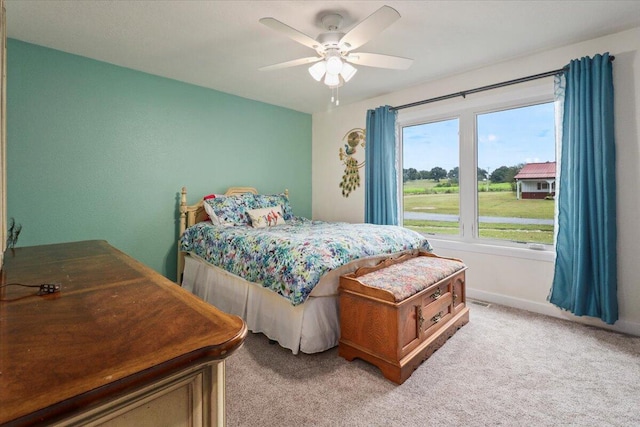 carpeted bedroom with ceiling fan