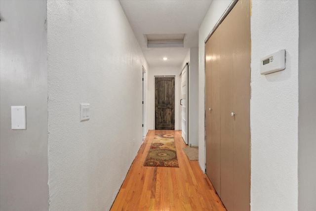 corridor with light hardwood / wood-style flooring