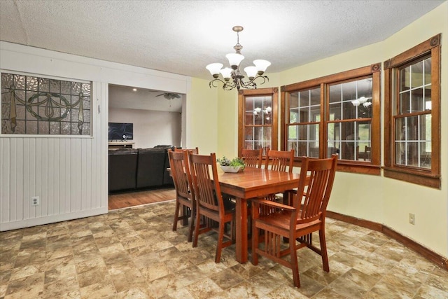 dining space featuring a notable chandelier and a textured ceiling