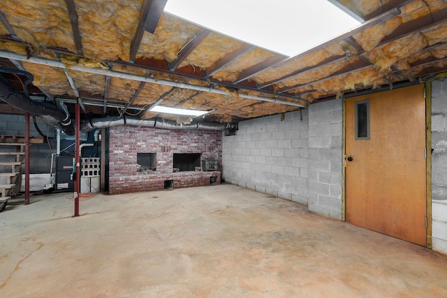 basement featuring a brick fireplace