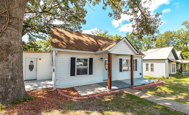 view of front of house with a front lawn and a patio