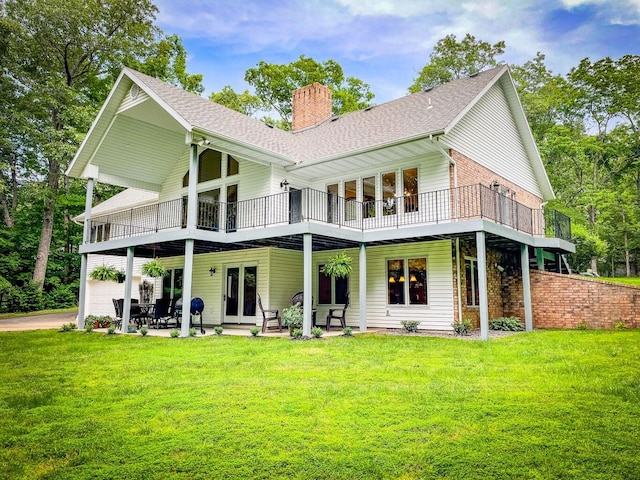 rear view of house with a patio area, a lawn, and a deck