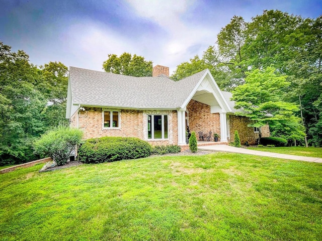 6643 E Turner Springs Dr, Springfield, MO 65809 - ranch-style home with a chimney, a shingled roof, a front yard, and brick siding