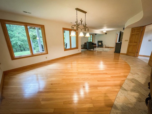 6643 E Turner Springs Dr, Springfield, MO 65809 - unfurnished dining area with light wood-style flooring, baseboards, and visible vents