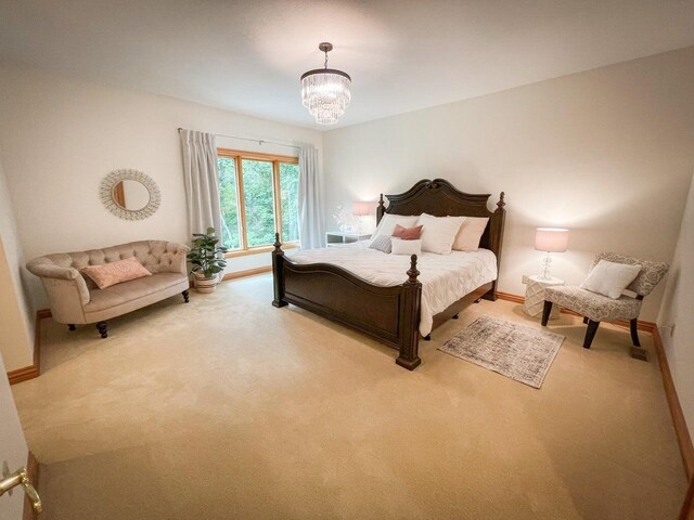 6643 E Turner Springs Dr, Springfield, MO 65809 - bedroom with a chandelier, baseboards, and carpet floors