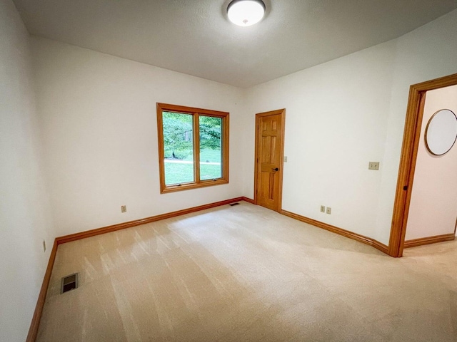 6643 E Turner Springs Dr, Springfield, MO 65809 - spare room featuring visible vents, light colored carpet, and baseboards