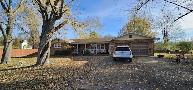 single story home featuring a porch and a garage