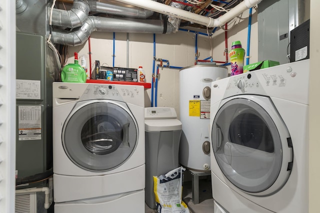 laundry room with independent washer and dryer, electric panel, and water heater