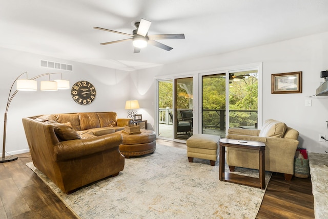 living room with ceiling fan and dark hardwood / wood-style flooring