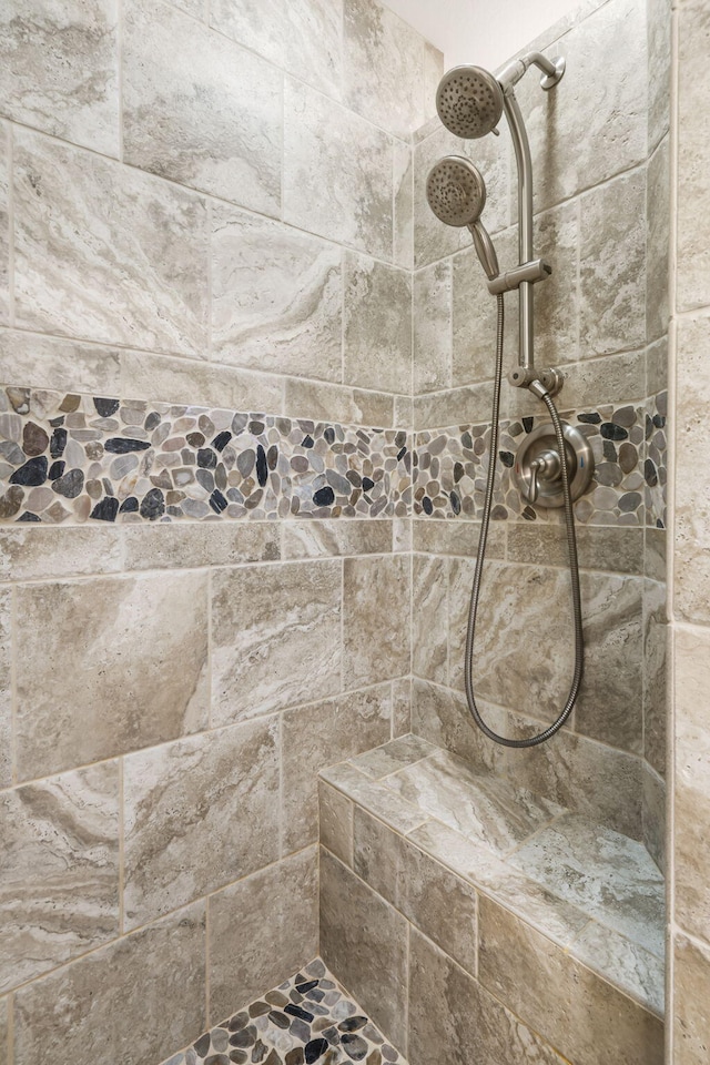 bathroom with a tile shower