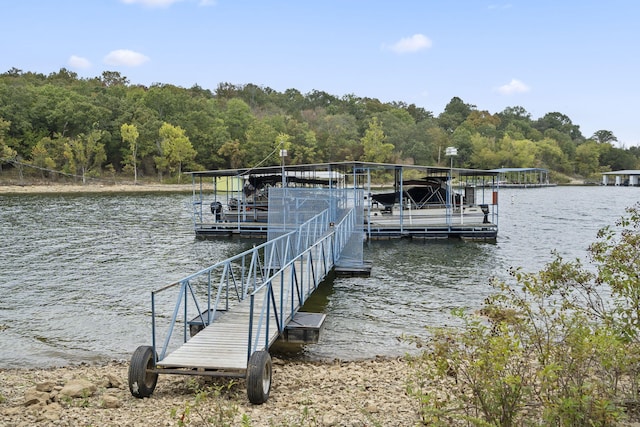 view of dock featuring a water view and a wooded view