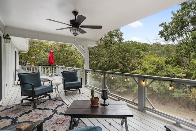 wooden deck featuring ceiling fan