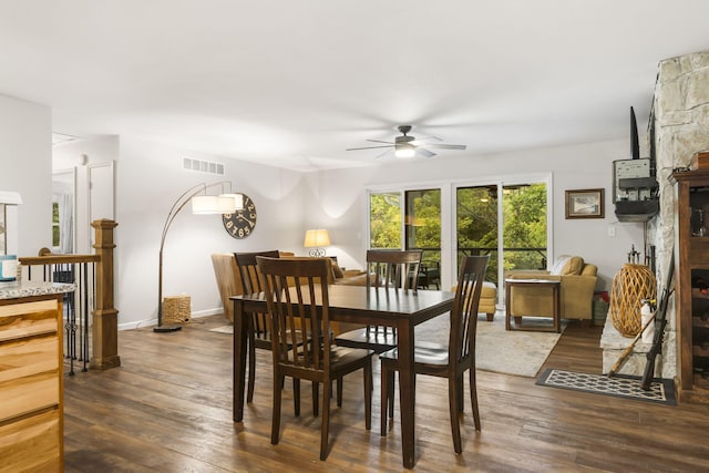 dining space featuring visible vents, ceiling fan, baseboards, and dark wood-style flooring