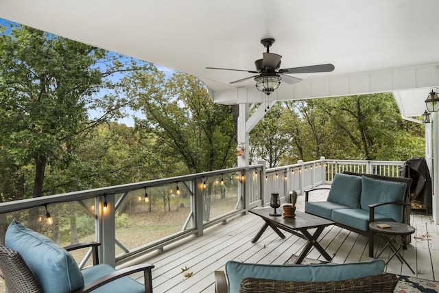 deck with a grill, ceiling fan, and outdoor lounge area