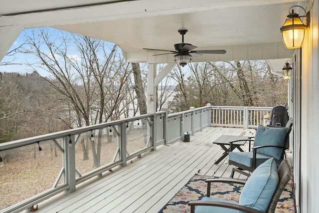 wooden terrace featuring ceiling fan