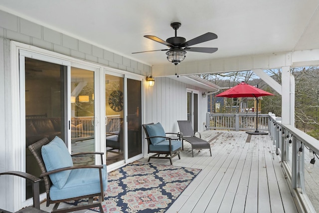 wooden terrace with a ceiling fan