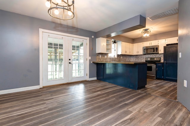 kitchen with dark hardwood / wood-style floors, blue cabinetry, stainless steel appliances, white cabinets, and decorative light fixtures