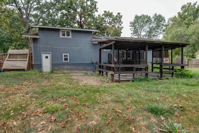 back of property featuring a lawn