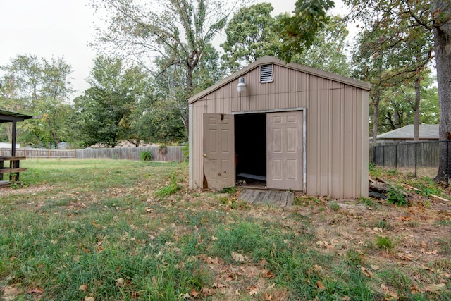 view of outbuilding with a lawn