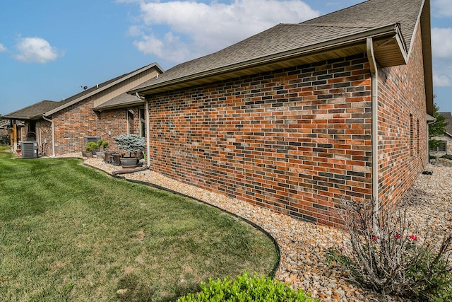 view of home's exterior with a yard and central AC