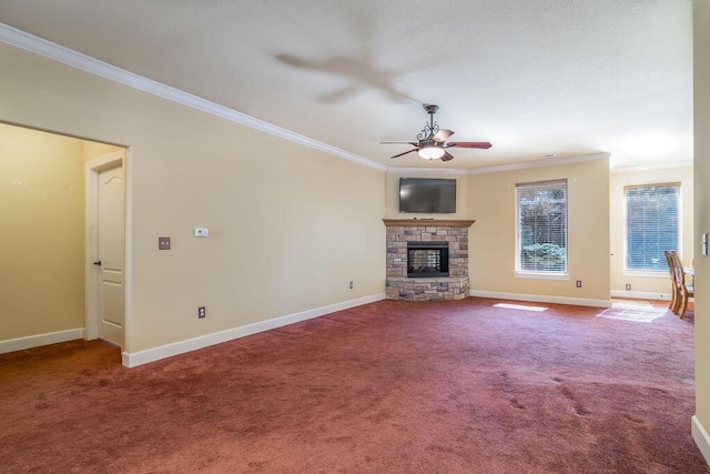 unfurnished living room featuring ceiling fan, ornamental molding, a fireplace, and carpet