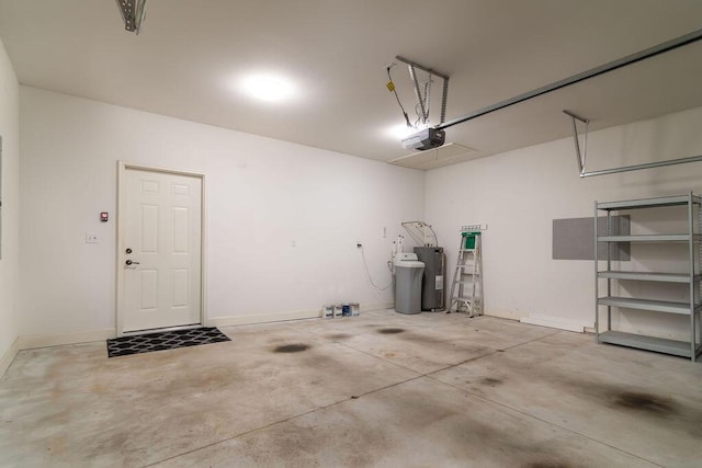 garage with a garage door opener and electric water heater