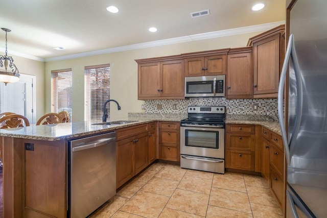 kitchen featuring appliances with stainless steel finishes, decorative light fixtures, sink, kitchen peninsula, and crown molding