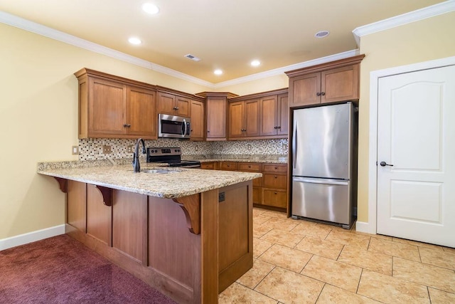 kitchen featuring sink, appliances with stainless steel finishes, ornamental molding, decorative backsplash, and kitchen peninsula