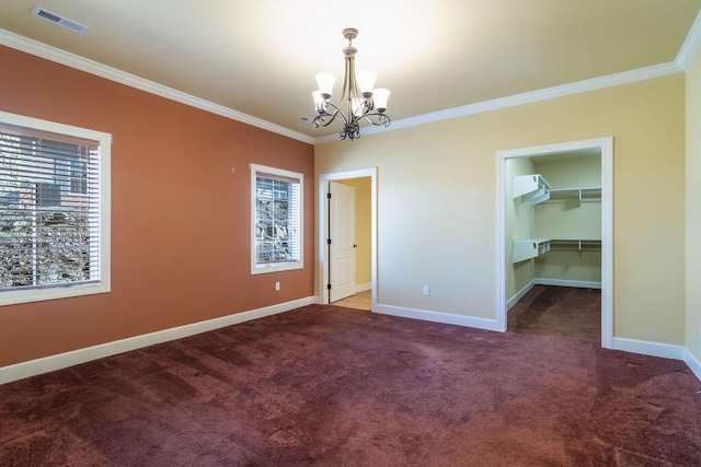 unfurnished room with ornamental molding, carpet floors, and an inviting chandelier