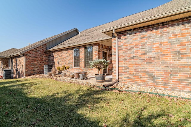 rear view of house featuring a yard and cooling unit