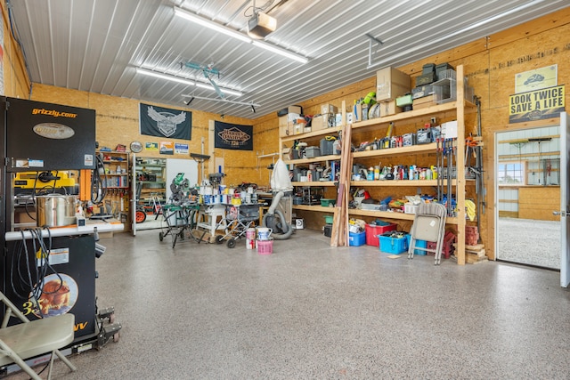 garage with a garage door opener and a workshop area