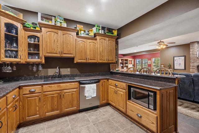 kitchen with ceiling fan, sink, stainless steel appliances, kitchen peninsula, and light tile patterned floors