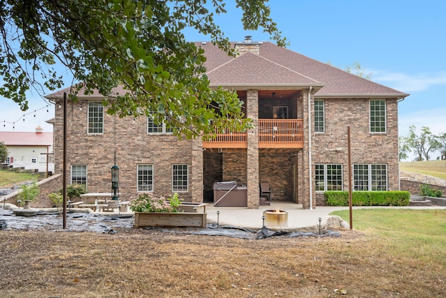 back of property featuring a patio, a yard, and a balcony