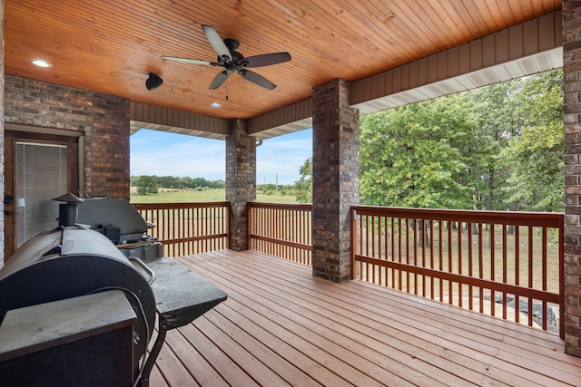 wooden terrace with a grill and ceiling fan