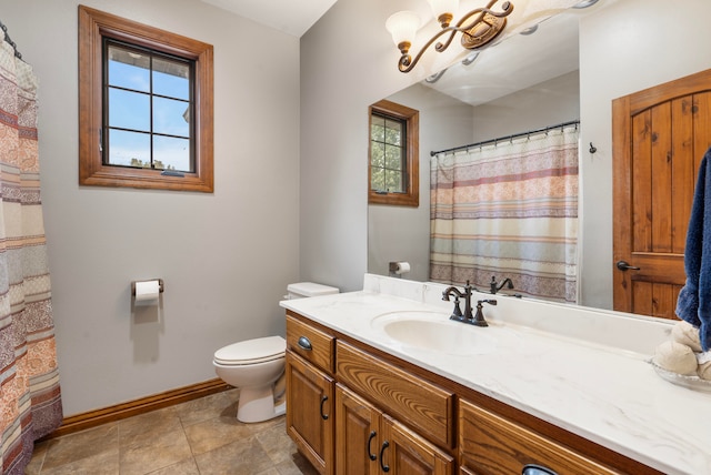 bathroom featuring tile patterned floors, toilet, and vanity