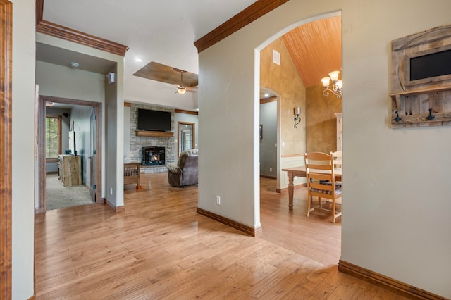 interior space featuring a notable chandelier, crown molding, and light hardwood / wood-style flooring