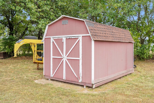 view of outdoor structure featuring a lawn