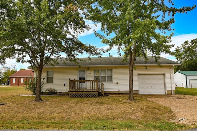 ranch-style house featuring a garage, a front yard, and a deck