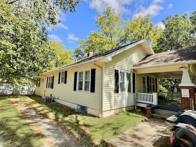 view of property exterior with covered porch and central air condition unit