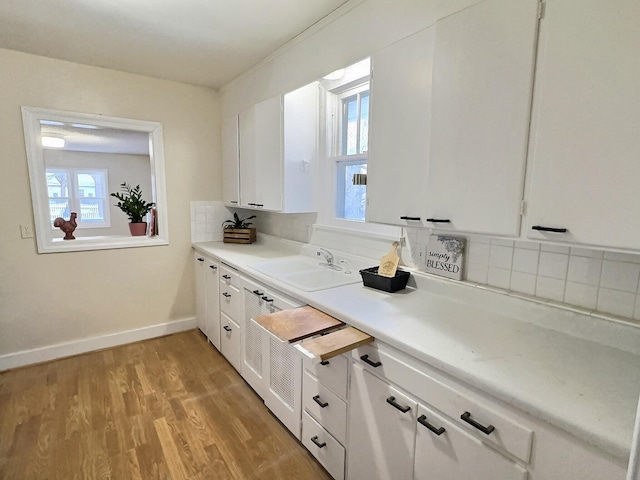 bathroom featuring wood-type flooring, vanity, and tasteful backsplash