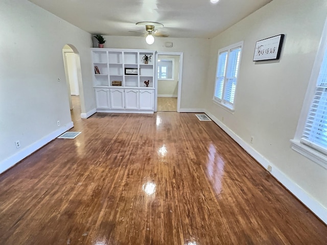 unfurnished living room with wood-type flooring and ceiling fan