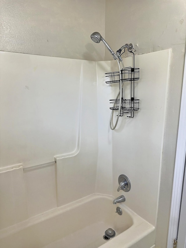 bathroom with shower / washtub combination