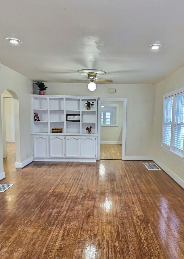 unfurnished living room with light wood-type flooring and ceiling fan