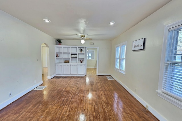 unfurnished living room featuring wood-type flooring and ceiling fan