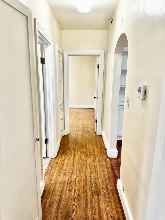 corridor with wood-type flooring