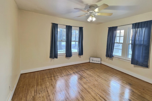 unfurnished room featuring ceiling fan and hardwood / wood-style floors