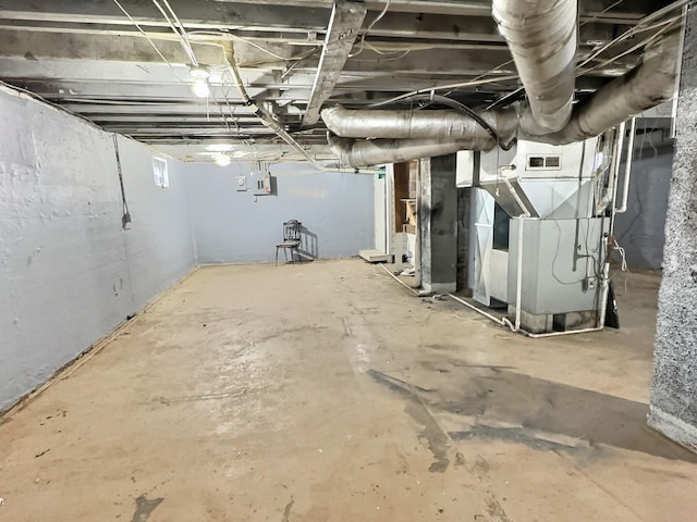 basement featuring heating unit and electric panel