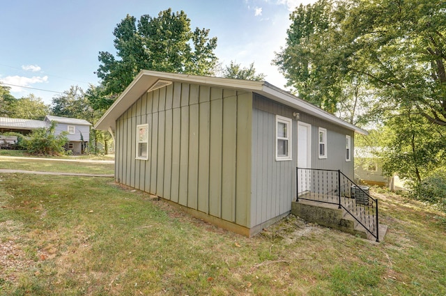 view of side of property with a yard