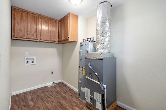 clothes washing area with hookup for a washing machine, dark wood-type flooring, hookup for an electric dryer, electric water heater, and cabinets