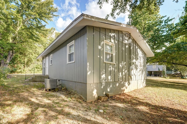 view of side of property with central air condition unit